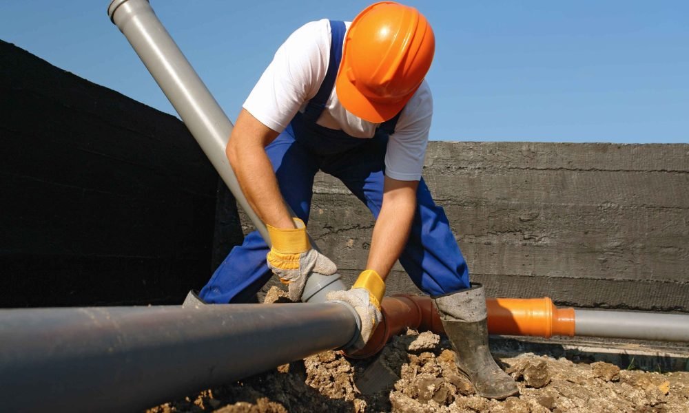 contractor-installing-a-sewer-line-with-permit-scaled